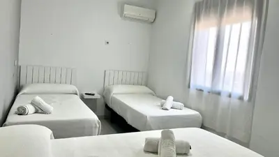 Cama o camas de una habitación en Hostal Carlos III