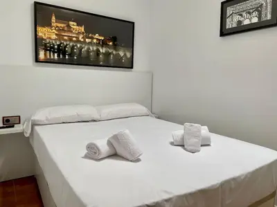 Cama o camas de una habitación en Geysotur Rincón de la Mezquita