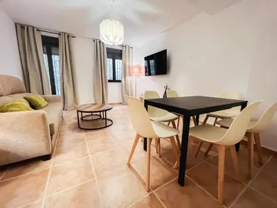 Una televisión o centro de entretenimiento en Nido Baeza Suites