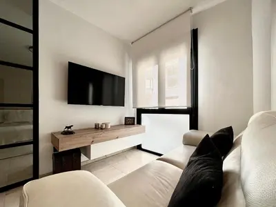 Una televisión o centro de entretenimiento en Suite Deluxe Gondomar
