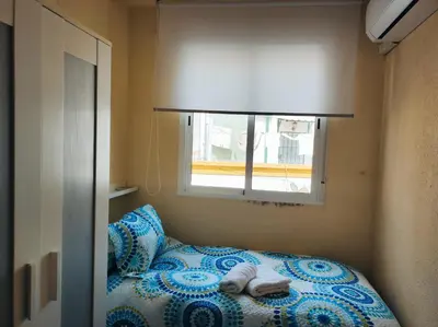 Cama o camas de una habitación en EN CÁ TITO. Luminoso y céntrico. Sevilla auténtica