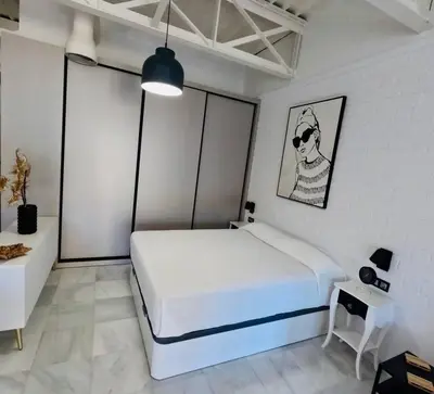 Cama o camas de una habitación en Loft Puerta de Capitulares
