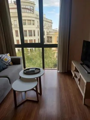 Una televisión o centro de entretenimiento en Apart Gran Teatro Centro