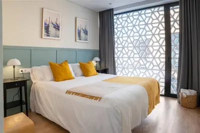 Cama o camas de una habitación en LeonAlba House Private Villa Private rooftop Private Pool Private Andalusian Courtyard Free Parking BBQ 8 Guests