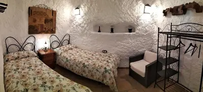 Cama o camas de una habitación en CASA CUEVA EL OLIVO