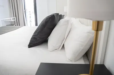 Cama o camas de una habitación en Apartamentos MLC Ciudad de Linares