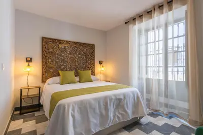 Cama o camas de una habitación en AL-QUIVIR Suites