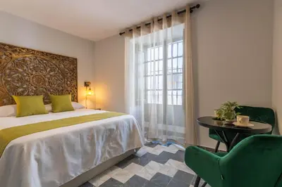 Cama o camas de una habitación en AL-QUIVIR Suites
