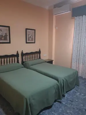 Cama o camas de una habitación en Hostal Hispalis