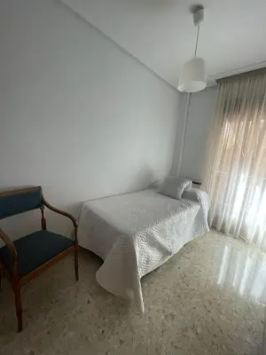 Cama o camas de una habitación en Alojamiento Comercio.