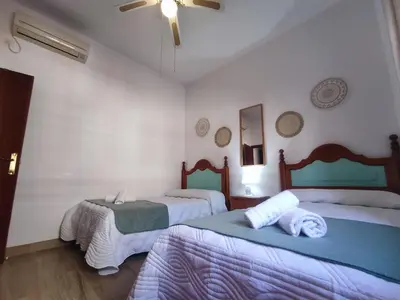 Cama o camas de una habitación en Apartamento Turístico Córdoba Centro Jardín