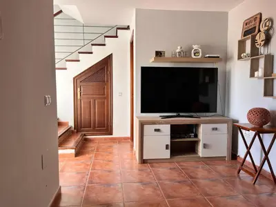 Una televisión o centro de entretenimiento en Casa con piscina en Málaga