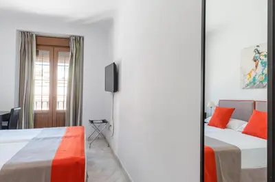 Cama o camas de una habitación en Cool Sevilla Hotel