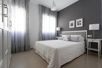 Cama o camas de una habitación en Apartamentos Diaber San Leandro