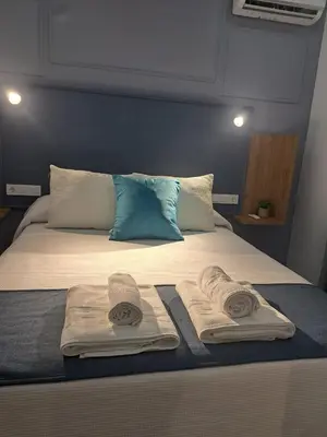 Cama o camas de una habitación en ALOJAMIENTOS EL LUGARILLO 1ºa