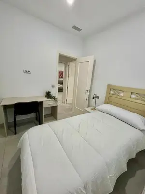 Cama o camas de una habitación en Duplex Agustín M con parking gratuito