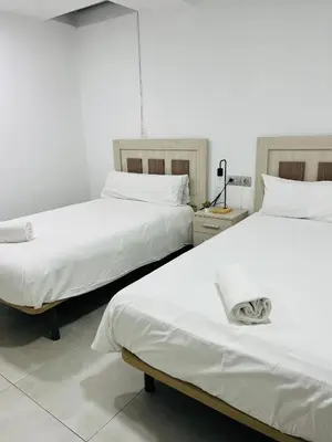Cama o camas de una habitación en Duplex Agustín M con parking gratuito