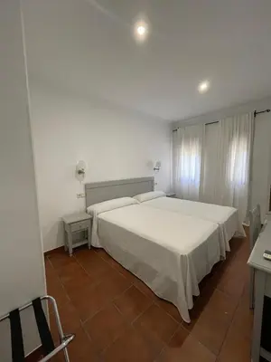 Cama o camas de una habitación en Villa María Hotel