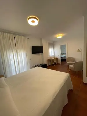 Cama o camas de una habitación en Villa María Hotel
