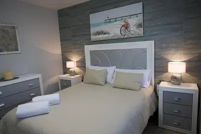 Cama o camas de una habitación en Apartamentos turísticos ilusiones