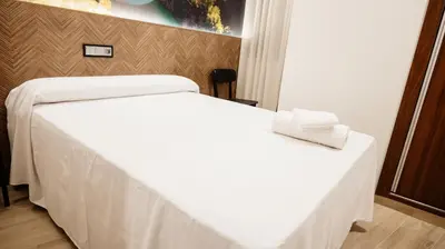 Cama o camas de una habitación en Hostal Central Marmolejo