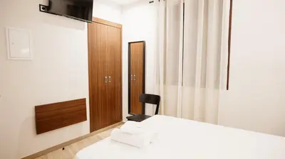 Cama o camas de una habitación en Hostal Central Marmolejo