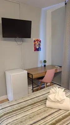 Una televisión o centro de entretenimiento en Habitaciones El Lagarto a gusto