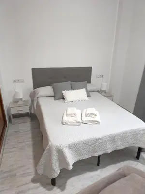 Cama o camas de una habitación en Apartamento FIBES II edificio LUX SEVILLA