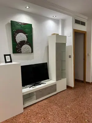 Una televisión o centro de entretenimiento en Apartamento espacioso El Olivo