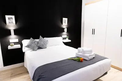 Cama o camas de una habitación en Alojamientos Carola Julio Burell, 74