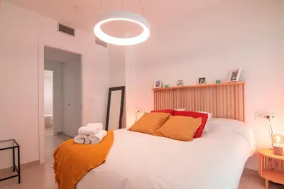 Cama o camas de una habitación en Edomus Puerta de la Barqueta