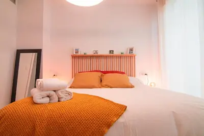 Cama o camas de una habitación en Edomus Puerta de la Barqueta