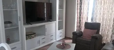 Una televisión o centro de entretenimiento en Apartamento el Arcángel
