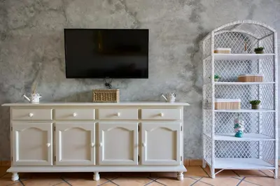 Una televisión o centro de entretenimiento en Apartamento turísticos ilusiones 1