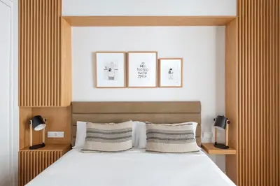 Cama o camas de una habitación en R26 Suites Sevilla