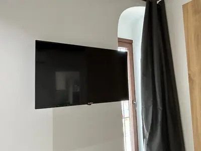 Una televisión o centro de entretenimiento en Casa Cuatro Esquinas