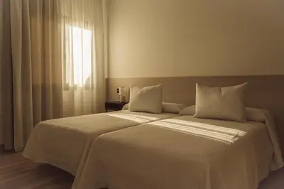 Cama o camas de una habitación en Oliva Suite Apartamentos