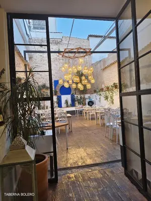 Un restaurante o sitio para comer en La Casa del Gallo Alojamientos by Taberna Bolero