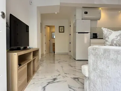 Una televisión o centro de entretenimiento en Apartamento Reina Centro Suite