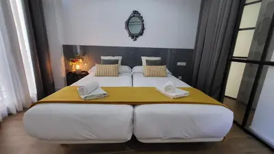 Cama o camas de una habitación en Hogarium Plaza de San Pedro