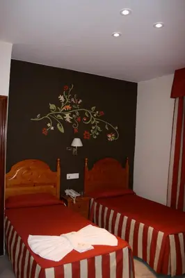 Cama o camas de una habitación en Hostal la Fuente