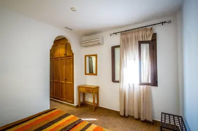 Cama o camas de una habitación en Apartamentos La Venta del Charco