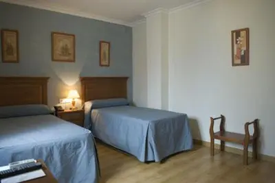 Cama o camas de una habitación en Hotel Esmeralda