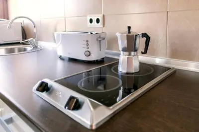 Una cocina o zona de cocina en Apartamentos Turísticos La Castilleja