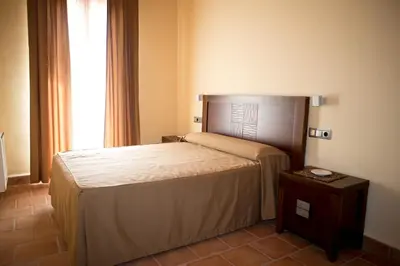 Cama o camas de una habitación en Apartamentos Turisticos Cortijo Garces