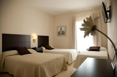 Cama o camas de una habitación en Hotel El Capricho