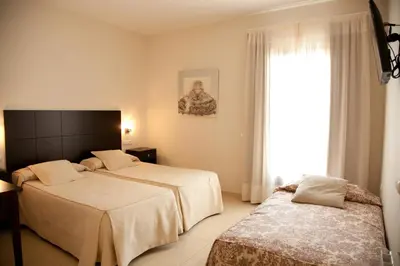 Cama o camas de una habitación en Hotel El Capricho