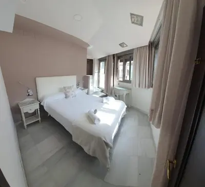 Cama o camas de una habitación en Apartamentos Torre de la Mezquita