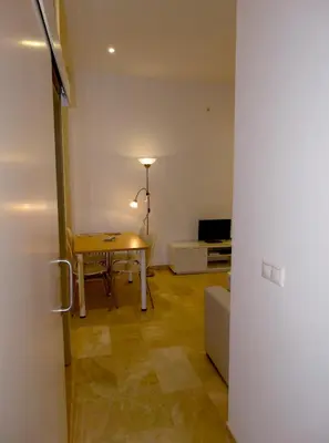 Una televisión o centro de entretenimiento en Minimalist Loft Center by gms apartamentos