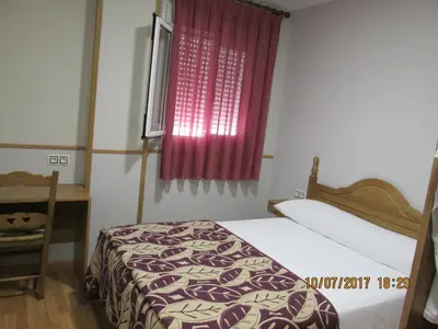 Cama o camas de una habitación en Hostal Banderas